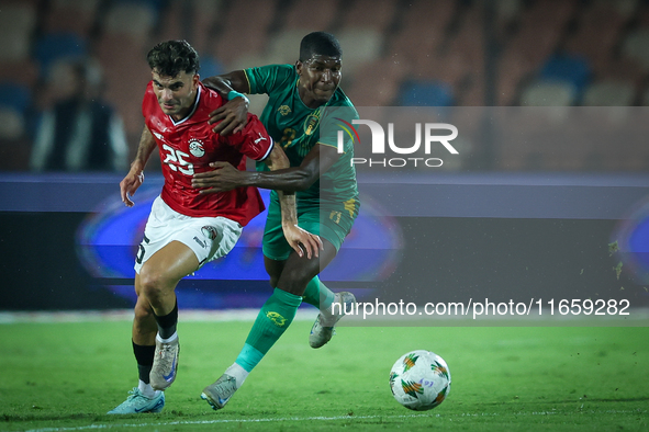 Ahmed Mostafa of Egypt battles for possession with Mouhsine Bodda of Mauritania during Africa Cup of Nations Qualifiers 2025 match number 61...