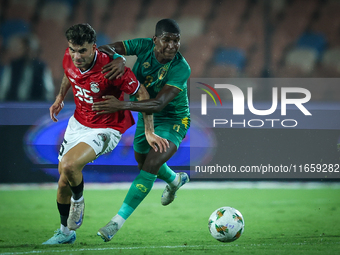 Ahmed Mostafa of Egypt battles for possession with Mouhsine Bodda of Mauritania during Africa Cup of Nations Qualifiers 2025 match number 61...