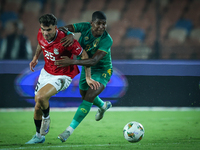 Ahmed Mostafa of Egypt battles for possession with Mouhsine Bodda of Mauritania during Africa Cup of Nations Qualifiers 2025 match number 61...