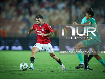 Ahmed Mostafa of Egypt battles for possession with Oumar Jacky Ngom of Mauritania during Africa Cup of Nations qualifiers 2025 match number...