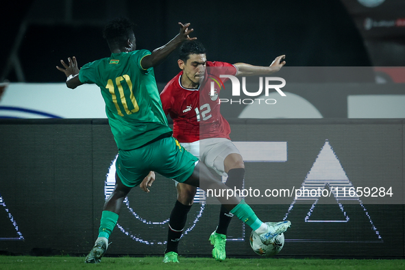 Mohamed Hamdy of Egypt battles for possession with Idrissa Thiam of Mauritania during Africa Cup of Nations Qualifiers 2025 match number 61...