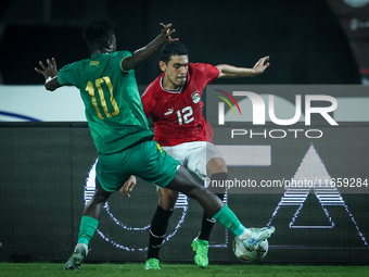 Mohamed Hamdy of Egypt battles for possession with Idrissa Thiam of Mauritania during Africa Cup of Nations Qualifiers 2025 match number 61...