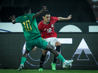 Mohamed Hamdy of Egypt battles for possession with Idrissa Thiam of Mauritania during Africa Cup of Nations Qualifiers 2025 match number 61...