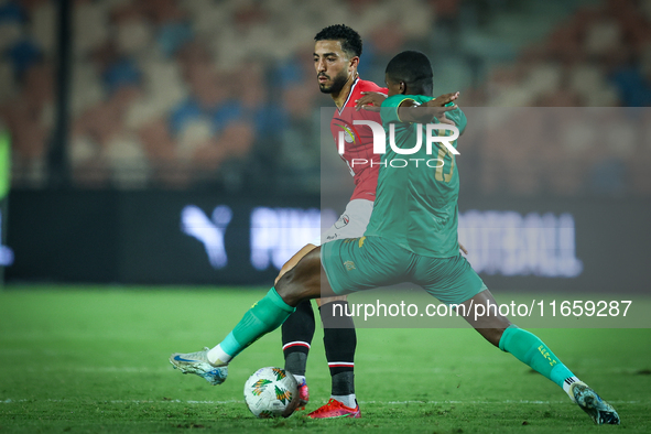 Mohamed Abdelmoneim of Egypt battles for possession with Mouhsine Bodda of Mauritania during Africa Cup of Nations Qualifiers 2025 match num...