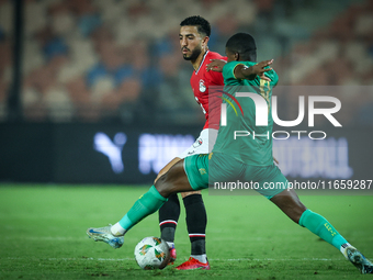 Mohamed Abdelmoneim of Egypt battles for possession with Mouhsine Bodda of Mauritania during Africa Cup of Nations Qualifiers 2025 match num...