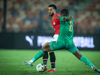 Mohamed Abdelmoneim of Egypt battles for possession with Mouhsine Bodda of Mauritania during Africa Cup of Nations Qualifiers 2025 match num...