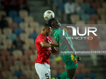 Ramy Rabiaa of Egypt battles for possession with Papa Ndiaga Yade of Mauritania during the Africa Cup of Nations Qualifiers 2025, match numb...