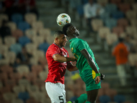 Ramy Rabiaa of Egypt battles for possession with Papa Ndiaga Yade of Mauritania during the Africa Cup of Nations Qualifiers 2025, match numb...