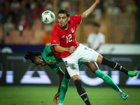 Mohamed Hamdy of Egypt battles for possession with Keita Ibrahima of Mauritania during the Africa Cup of Nations Qualifiers 2025, match numb...