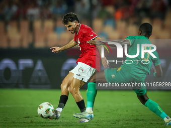 Ahmed Mostafa of Egypt battles for possession with Mouhsine Bodda of Mauritania during Africa Cup of Nations Qualifiers 2025 match number 61...