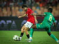 Ahmed Mostafa of Egypt battles for possession with Mouhsine Bodda of Mauritania during Africa Cup of Nations Qualifiers 2025 match number 61...