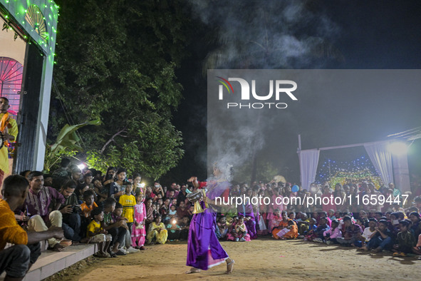 Bengali Hindu devotees watch a dance performance in front of an idol of the goddess Durga during the Durga Puja festival in Sylhet, Banglade...