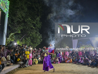 Bengali Hindu devotees watch a dance performance in front of an idol of the goddess Durga during the Durga Puja festival in Sylhet, Banglade...