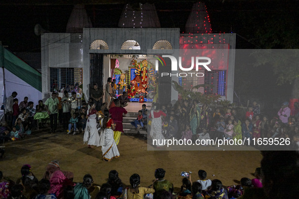 Bengali Hindu devotees watch a dance performance in front of an idol of the goddess Durga during the Durga Puja festival in Sylhet, Banglade...