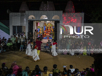 Bengali Hindu devotees watch a dance performance in front of an idol of the goddess Durga during the Durga Puja festival in Sylhet, Banglade...