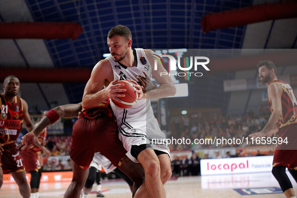 Ante Zizic of Virtus Bologna competes against Aamir Simms of Umana Reyer during the Italian LBA basketball championship match between Umana...