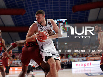 Ante Zizic of Virtus Bologna competes against Aamir Simms of Umana Reyer during the Italian LBA basketball championship match between Umana...