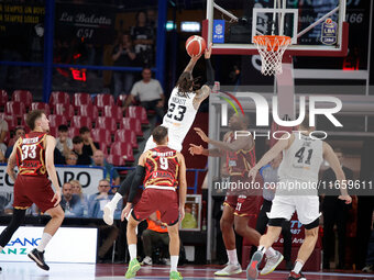 Achille Polonara of Virtus Bologna competes against Mfiondo Kabangele and Davide Moretti of Umana Reyer during the Italian LBA basketball ch...