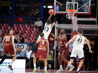 Achille Polonara of Virtus Bologna competes against Mfiondo Kabangele and Davide Moretti of Umana Reyer during the Italian LBA basketball ch...