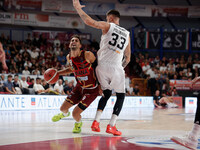 Umana Reyer's Davide Moretti competes against Virtus Bologna's Achille Polonara during the Italian LBA basketball championship match between...