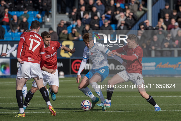 Barrow's Ged Garner is in action with Morecambe's Tom White during the Sky Bet League 2 match between Barrow and Morecambe at Holker Street...