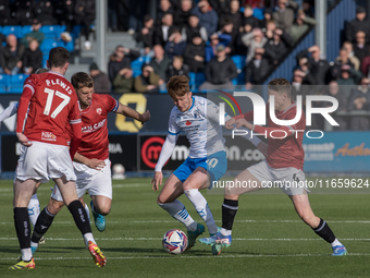 Barrow's Ged Garner is in action with Morecambe's Tom White during the Sky Bet League 2 match between Barrow and Morecambe at Holker Street...