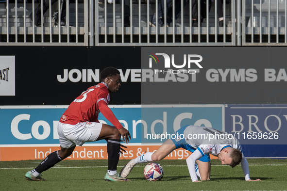 David Tutonda of Morecambe battles with Elliot Newby of Barrow during the Sky Bet League 2 match between Barrow and Morecambe at Holker Stre...