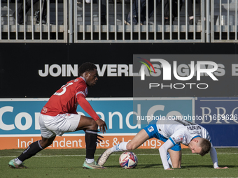 David Tutonda of Morecambe battles with Elliot Newby of Barrow during the Sky Bet League 2 match between Barrow and Morecambe at Holker Stre...