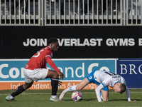 David Tutonda of Morecambe battles with Elliot Newby of Barrow during the Sky Bet League 2 match between Barrow and Morecambe at Holker Stre...