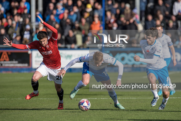 Barrow's Ged Garner is in action with Morecambe's Callum Jones during the Sky Bet League 2 match between Barrow and Morecambe at Holker Stre...