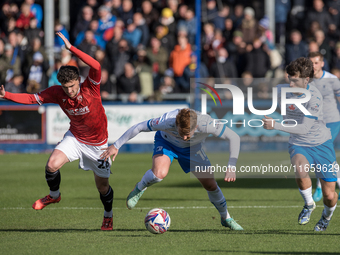 Barrow's Ged Garner is in action with Morecambe's Callum Jones during the Sky Bet League 2 match between Barrow and Morecambe at Holker Stre...