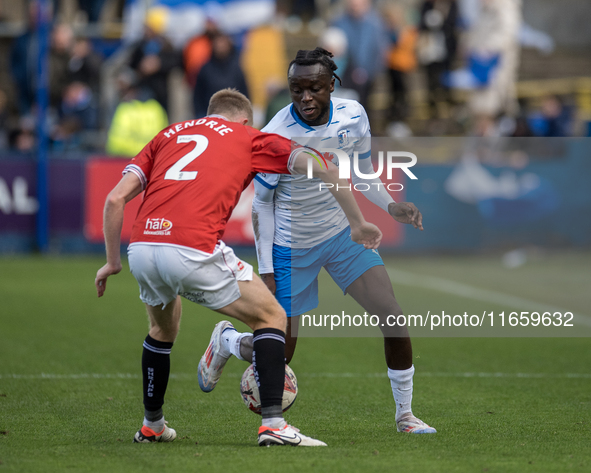 Barrow's Katia Kouyate is in action with Morecambe's Luke Hendrie during the Sky Bet League 2 match between Barrow and Morecambe at Holker S...