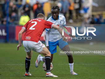 Barrow's Katia Kouyate is in action with Morecambe's Luke Hendrie during the Sky Bet League 2 match between Barrow and Morecambe at Holker S...