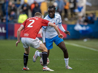 Barrow's Katia Kouyate is in action with Morecambe's Luke Hendrie during the Sky Bet League 2 match between Barrow and Morecambe at Holker S...