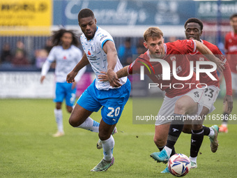 Barrow's Emile Acquah battles with Morecambe's Jamie Stott during the Sky Bet League 2 match between Barrow and Morecambe at Holker Street i...