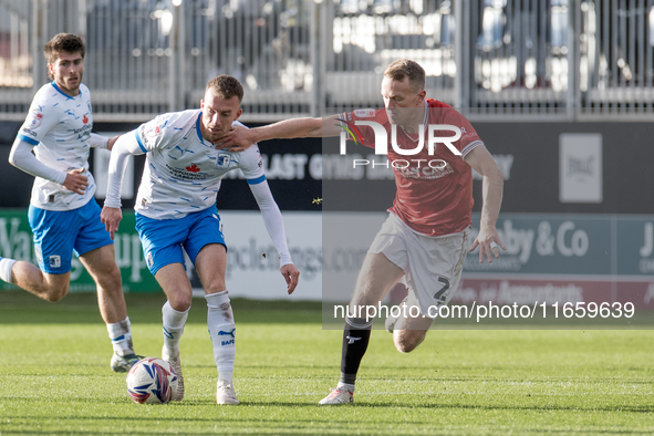 Elliot Newby of Barrow battles for possession with Luke Hendrie of Morecambe during the Sky Bet League 2 match between Barrow and Morecambe...