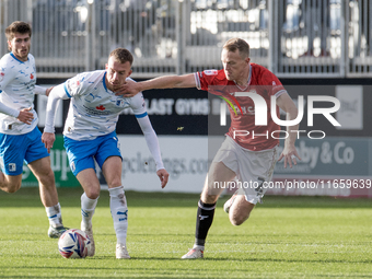 Elliot Newby of Barrow battles for possession with Luke Hendrie of Morecambe during the Sky Bet League 2 match between Barrow and Morecambe...