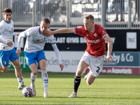 Elliot Newby of Barrow battles for possession with Luke Hendrie of Morecambe during the Sky Bet League 2 match between Barrow and Morecambe...