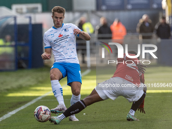 Andrew Dallas of Barrow competes with David Tutonda of Morecambe during the Sky Bet League 2 match between Barrow and Morecambe at Holker St...