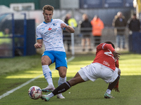 Andrew Dallas of Barrow competes with David Tutonda of Morecambe during the Sky Bet League 2 match between Barrow and Morecambe at Holker St...