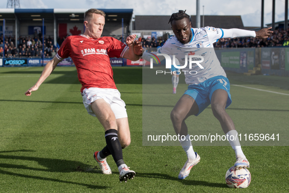 Katia Kouyate of Barrow battles with Luke Hendrie of Morecambe during the Sky Bet League 2 match between Barrow and Morecambe at Holker Stre...