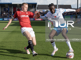 Katia Kouyate of Barrow battles with Luke Hendrie of Morecambe during the Sky Bet League 2 match between Barrow and Morecambe at Holker Stre...