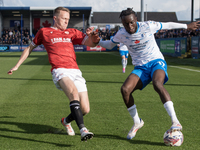 Katia Kouyate of Barrow battles with Luke Hendrie of Morecambe during the Sky Bet League 2 match between Barrow and Morecambe at Holker Stre...