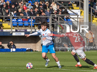 Kian Spence of Barrow competes with Callum Jones of Morecambe during the Sky Bet League 2 match between Barrow and Morecambe at Holker Stree...