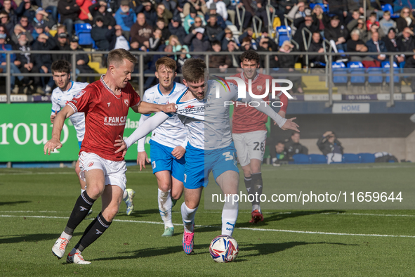 Ben Jackson of Barrow battles with Luke Hendrie of Morecambe during the Sky Bet League 2 match between Barrow and Morecambe at Holker Street...