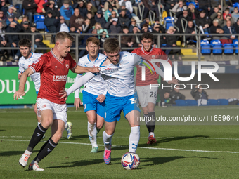 Ben Jackson of Barrow battles with Luke Hendrie of Morecambe during the Sky Bet League 2 match between Barrow and Morecambe at Holker Street...