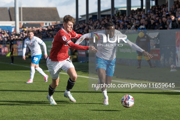 Katia Kouyate of Barrow battles with Ben Tollitt of Morecambe during the Sky Bet League 2 match between Barrow and Morecambe at Holker Stree...