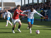 Katia Kouyate of Barrow battles with Ben Tollitt of Morecambe during the Sky Bet League 2 match between Barrow and Morecambe at Holker Stree...