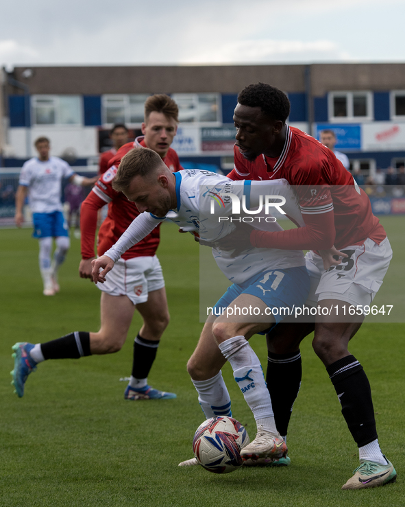 Elliot Newby of Barrow battles with David Tutonda of Morecambe during the Sky Bet League 2 match between Barrow and Morecambe at Holker Stre...