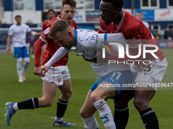 Elliot Newby of Barrow battles with David Tutonda of Morecambe during the Sky Bet League 2 match between Barrow and Morecambe at Holker Stre...